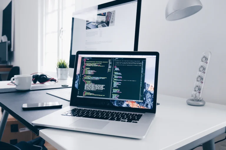 Laptop with code on a bright desk